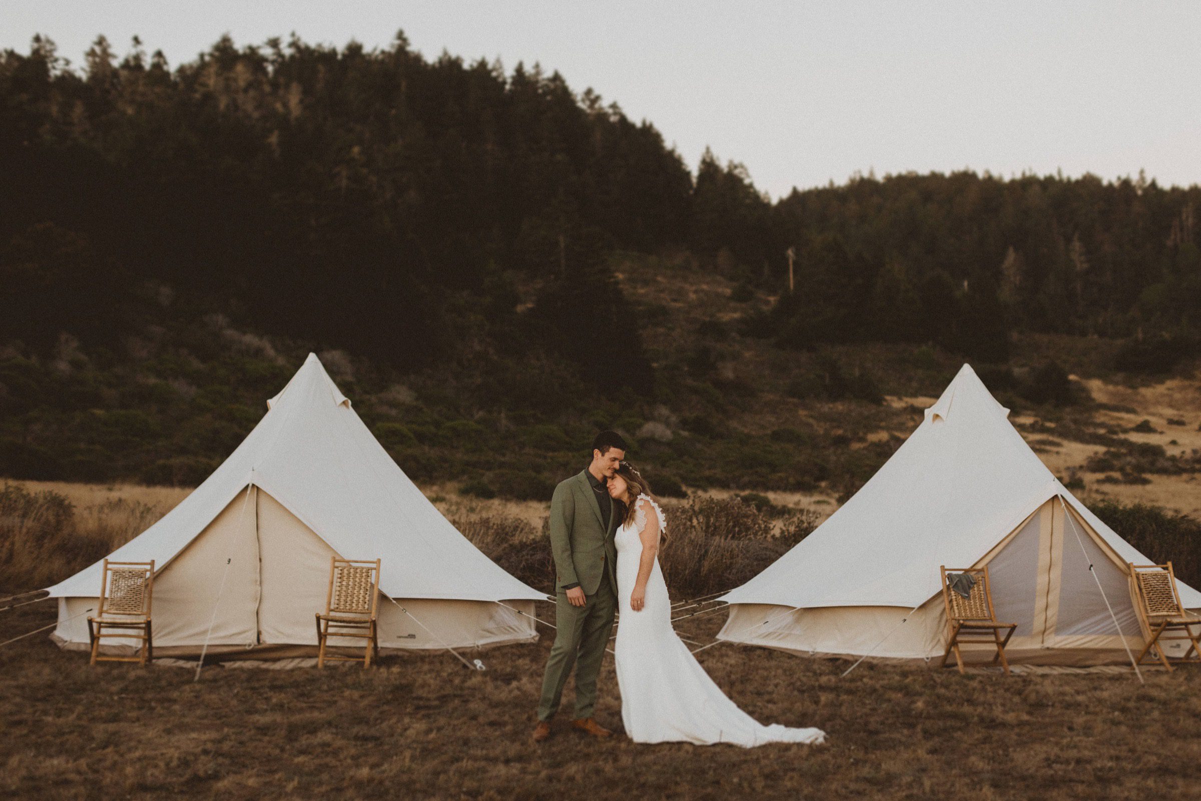 Glamping tents with bride and groom